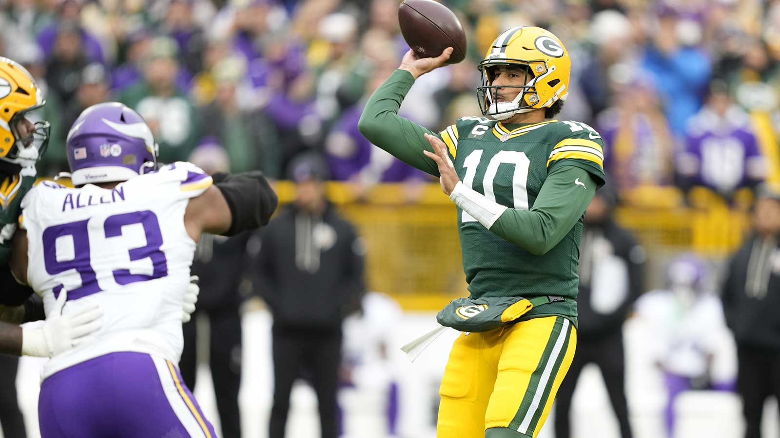 Green Bay Packers quarterback Jordan Love (10) looks to throw downfield as Minnesota Vikings defensive tackle Jonathan Allen (93) applies pressure during the first half at Lambeau Field. 