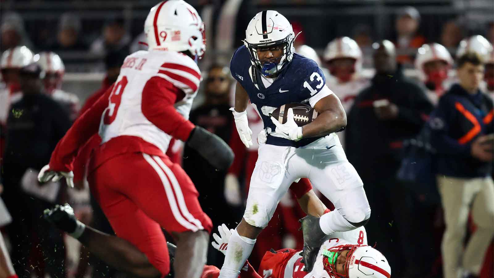 Penn State Nittany Lions running back Kaytron Allen (13) runs with the ball while trying to avoid a tackle from Nebraska Cornhuskers defensive back DeShon Singleton (8) during the second quarter at Beaver Stadium.