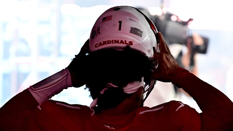Kyler Murray prepares on the sideline before a Cardinals game.