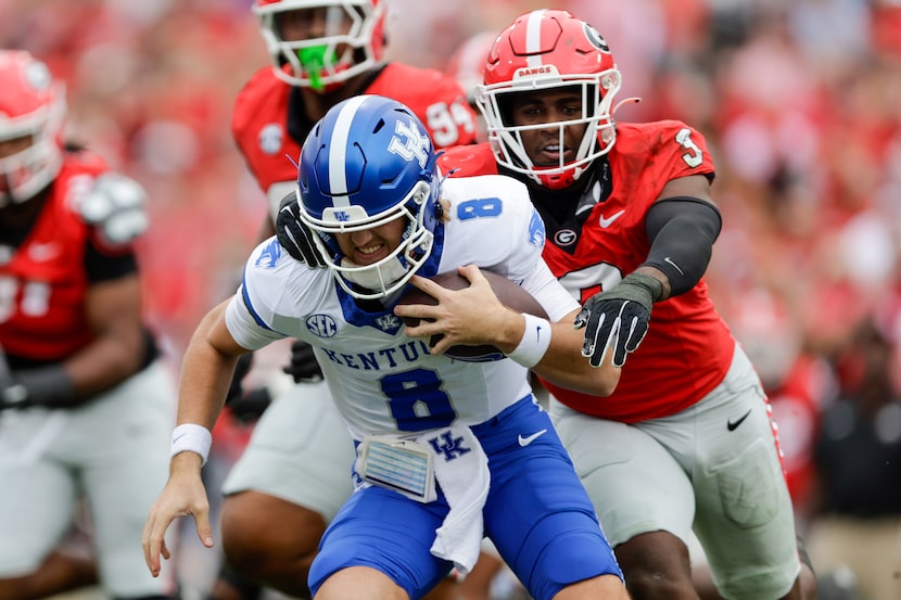 Kentucky quarterback Cutter Boley (8) is sacked by Georgia inside linebacker CJ Allen (3)...
