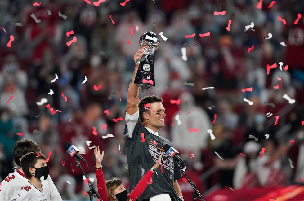 Tampa Bay Buccaneers quarterback Tom Brady holds up the Vince Lombardi trophy after defeating...