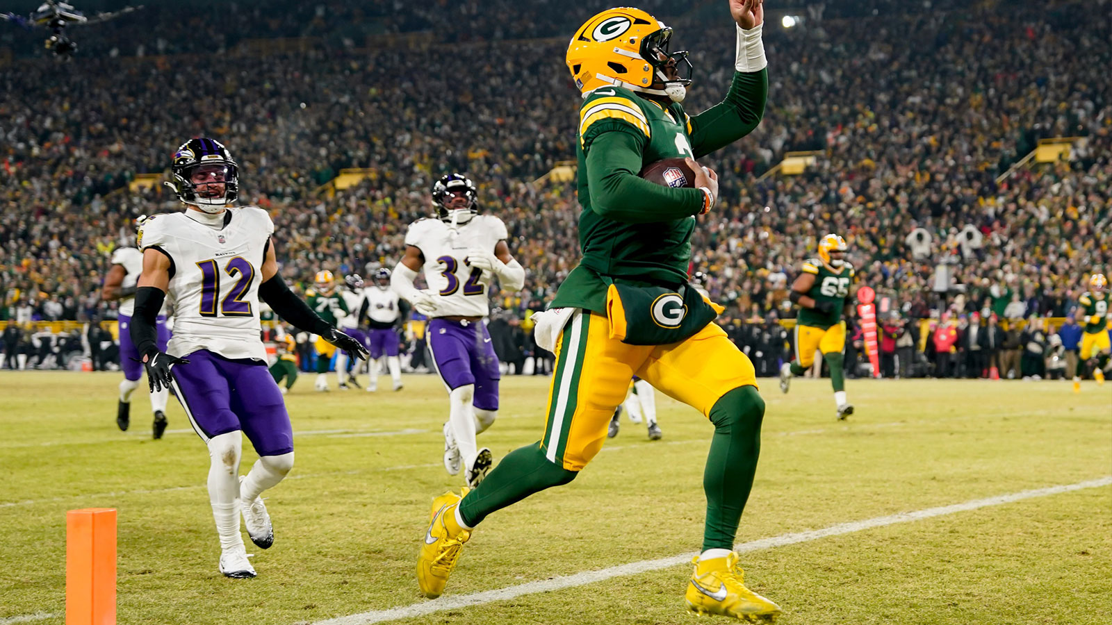 Green Bay Packers quarterback Malik Willis (2) runs for a touchdown during the second quarter against the Baltimore Ravens at Lambeau Field.