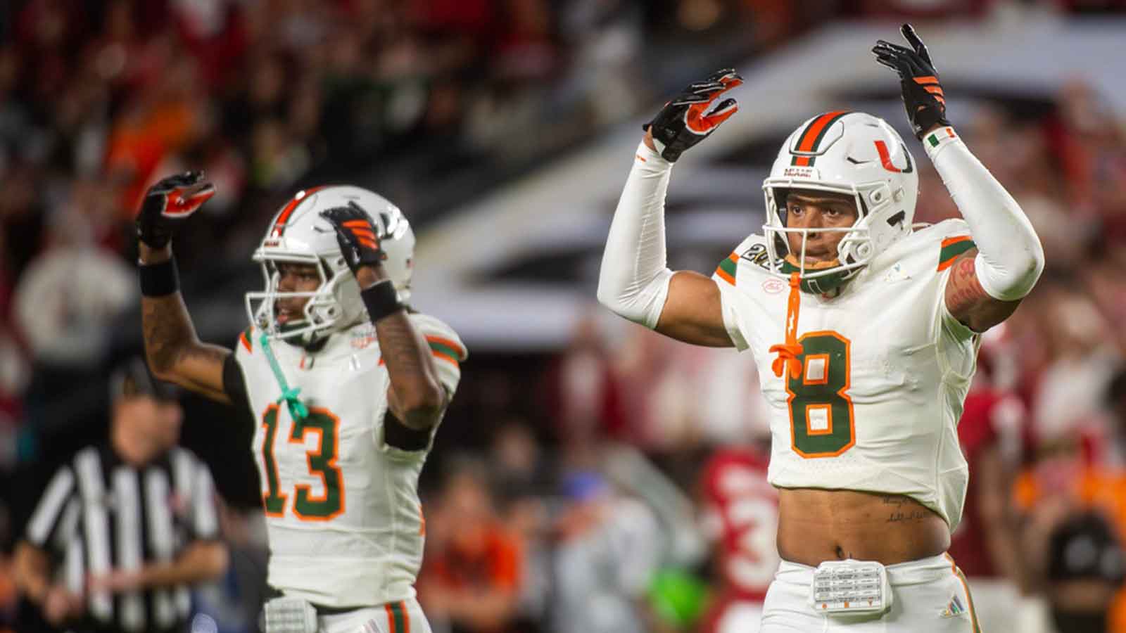 Miami's Jakobe Thomas (8) and Bryce Fitzgerald (13) get the crowd hyped during the College Football Playoff National Championship college football game at Hard Rock Stadium in Miami Gardens on Monday, Jan. 19, 2026.