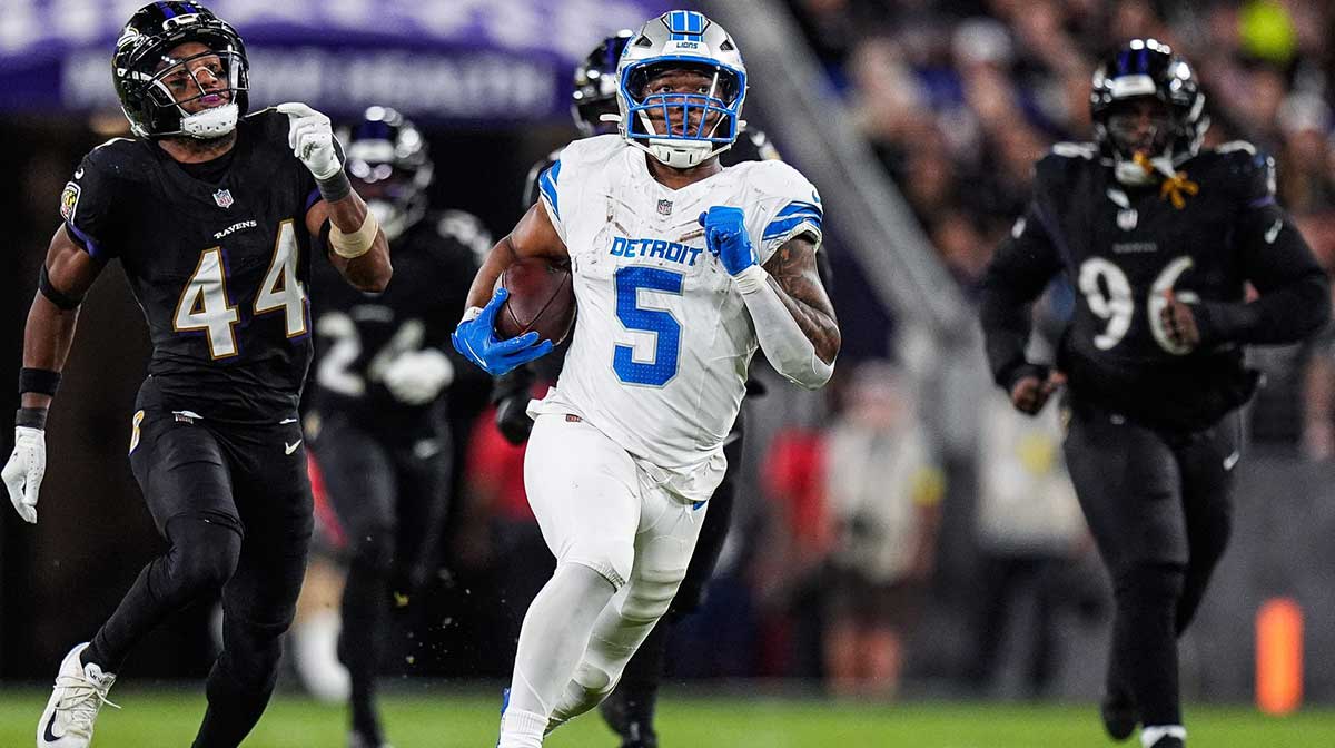 Detroit Lions running back David Montgomery (5) runs against Baltimore Ravens cornerback Marlon Humphrey (44) and defensive tackle Broderick Washington (96) during the second half at M&T Bank Stadium in Baltimore, Md. on Monday, Sept. 22, 2025.