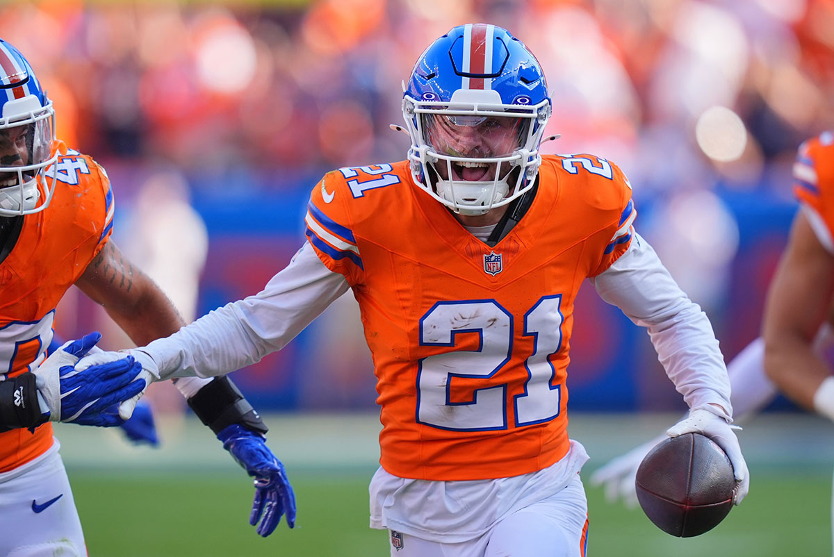 Oct 6, 2024; Denver, Colorado, USA; Denver Broncos cornerback Riley Moss (21) celebrates his interception in the second half against the Las Vegas Raiders at Empower Field at Mile High.