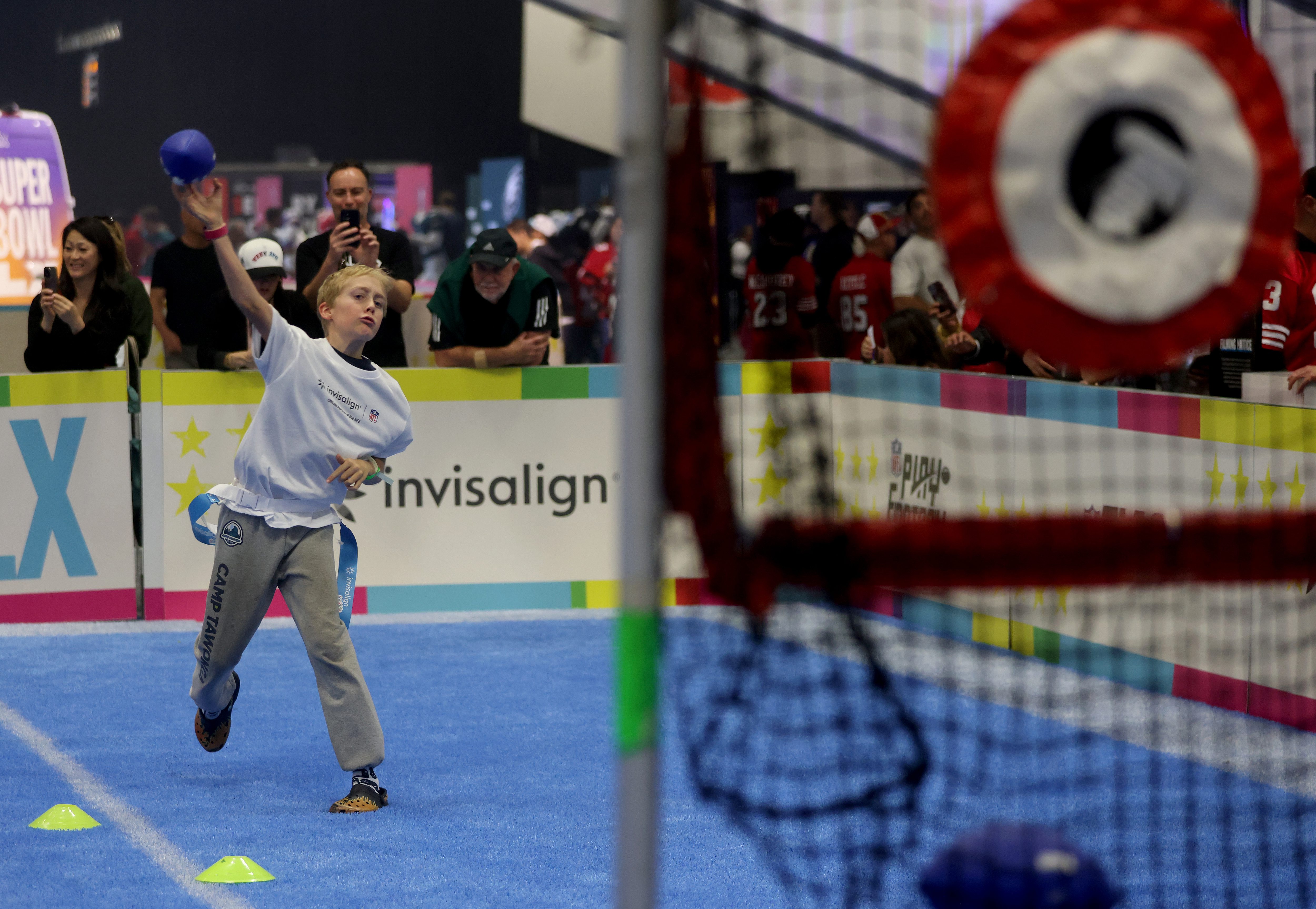 A young NFL fan practices his passing during the first...