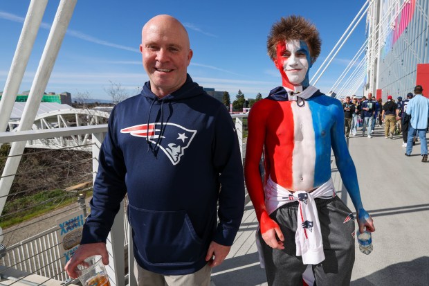 New England Patriots fans Christian Roux, left, and his 16-year-old son, Kelton, of Nevada, make their way to support their team in Super Bowl 60 against the Seattle Seahawks at Levi's Stadium in Santa Clara, Calif., on Sunday, Feb. 8, 2026. (Ray Chavez/Bay Area News Group)