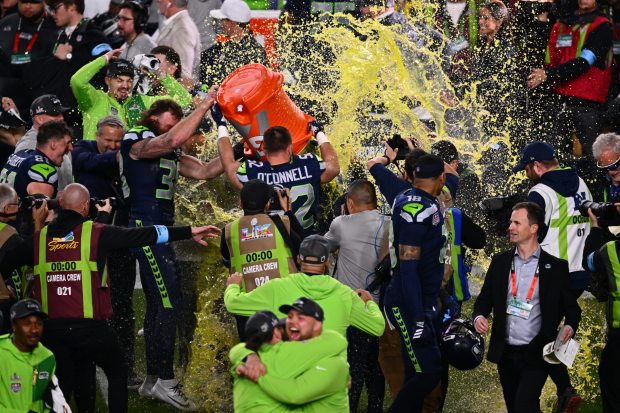 Seattle Seahawks fullback Brady Russell (38) celebrates after dousing head coach Mike Macdonald with Gatorade after defeating the New England Patriots at the NFL Super Bowl 60 game in Santa Clara, Calif., Sunday, February 8, 2026. (Jose Carlos Fajardo/Bay Area News Group)