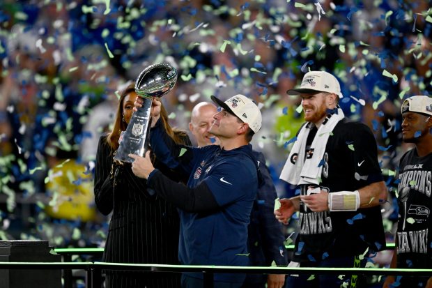 Seattle Seahawks head coach Mike MacDonald holds the Lombardi Trophy next to quarterback Sam Darnold after the NFL Super Bowl 60 football game against the New England Patriots, Sunday, Feb. 8, 2026, in Santa Clara, Calif. (Jose Carlos Fajardo/Bay Area News Group)