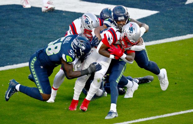 New England Patriots' Rhamondre Stevenson (38) gets tackled in the first quarter of Super Bowl 60 at Levi's Stadium in Santa Clara, Calif., on Sunday, Feb. 8, 2026. (Jose Carlos Fajardo/Bay Area News Group)