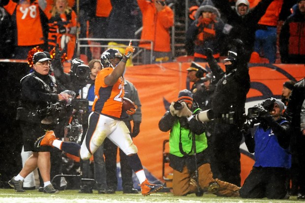 Bethel High graduate C.J. Anderson of the Denver Broncos carries the ball on Sunday for an overtime touchdown to defeat the New England Patriots 30-24. - Dustin Bradford Getty Images