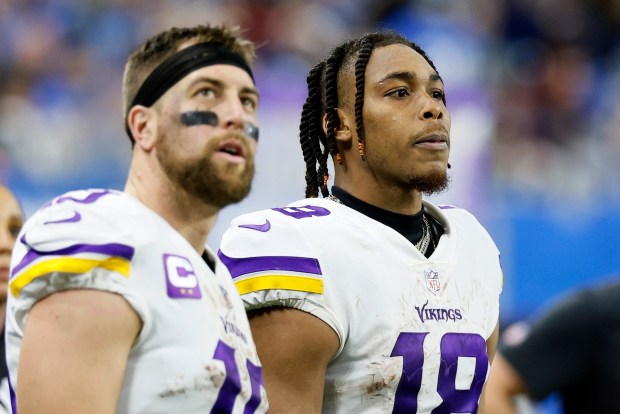 FILE - Minnesota Vikings wide receivers Adam Thielen, left, and Justin Jefferson (18) watch from the sideline during the second half of an NFL football game against the Detroit Lions, Sunday, Dec. 11, 2022, in Detroit. (AP Photo/Duane Burleson, File)
