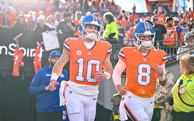 Bo Nix (10) and Jarrett Stidham (8) of the Denver Broncos take the field before the game against the Los Angeles Chargers at Empower Field at Mile High in Denver, Colorado on Sunday, Jan. 4, 2026. (Photo by AAron Ontiveroz/The Denver Post)