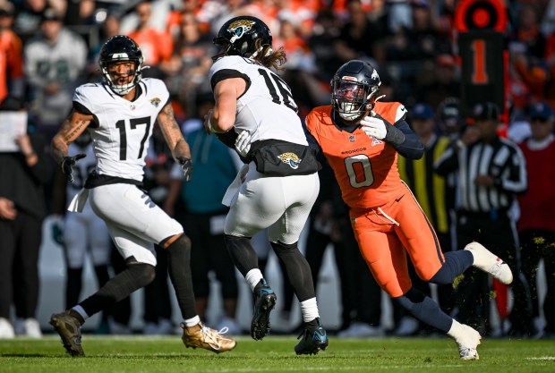 Jonathon Cooper (0) of the Denver Broncos forces an incompletion by Trevor Lawrence (16) of the Jacksonville Jaguars as Tim Patrick (17) watches during the first quarter at Empower Field at Mile High in Denver on Sunday, Dec. 21, 2025. (Photo by AAron Ontiveroz/The Denver Post)