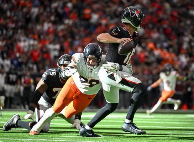 Zach Allen (99) of the Denver Broncos knocks down Davis Mills (10) of the Houston Texans as he gets off an incomplete pass during the fourth quarter of the Broncos' 18-15 win at NRG Stadium in Houston, Texas on Sunday, Nov. 2, 2025. (Photo by AAron Ontiveroz/The Denver Post)