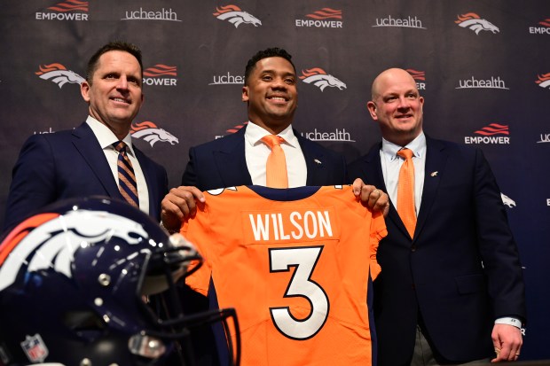 Denver Broncos quarterback Russell Wilson introduced by GM George Paton, left, and head coach Nathaniel Hackett at Denver Broncos Headquarters in Englewood, Colorado on Wednesday, March 16, 2022. (Photo by Hyoung Chang/The Denver Post)