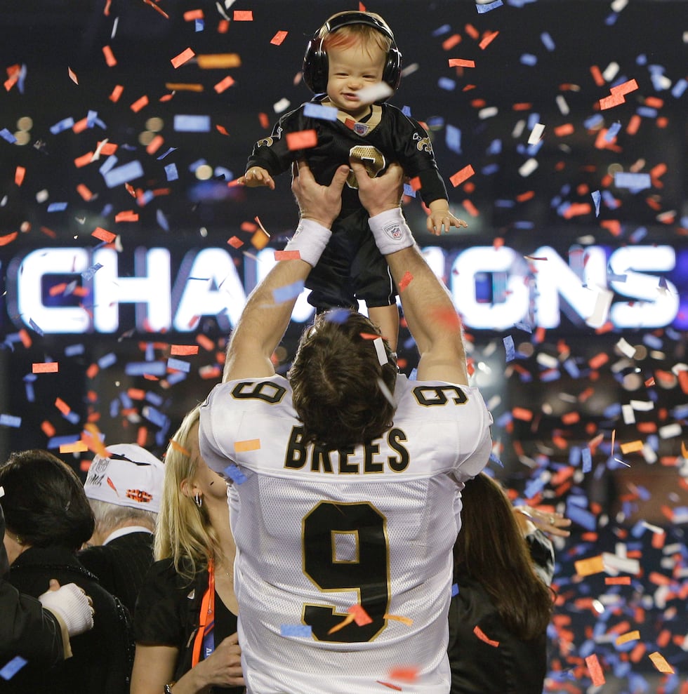 New Orleans Saints quarterback Drew Brees (9) holds his son Baylen after the NFL Super Bowl...