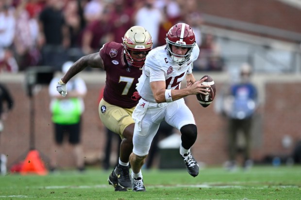 Alabama quarterback Ty Simpson escapes from Florida State linebacker Stefon Thompson during an Aug. 30 game in Tallahassee, Fla. (Phelan M. Ebenhack - The Associated Press)