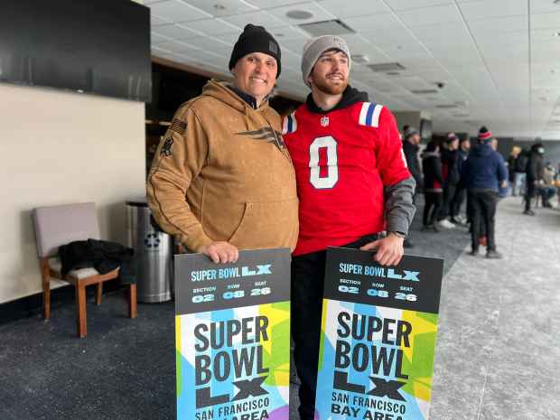 Aaron Tarver, left, and his son, Duncan Tarver, right, of Dighton, are going to the Super Bowl after scoring a pair of tickets at the Patriots send-off rally at Gillette Stadium. (Lance Reynolds/Boston Herald)