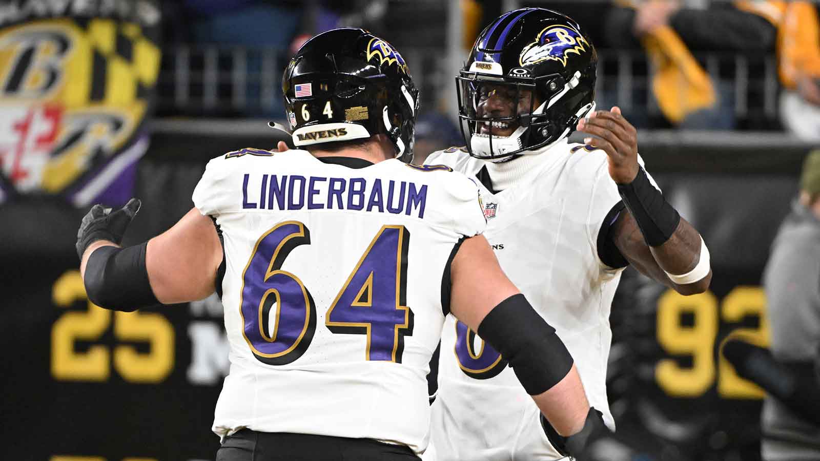 Baltimore Ravens center Tyler Linderbaum (64) and Baltimore Ravens quarterback Lamar Jackson (8) react before the game at Acrisure Stadium