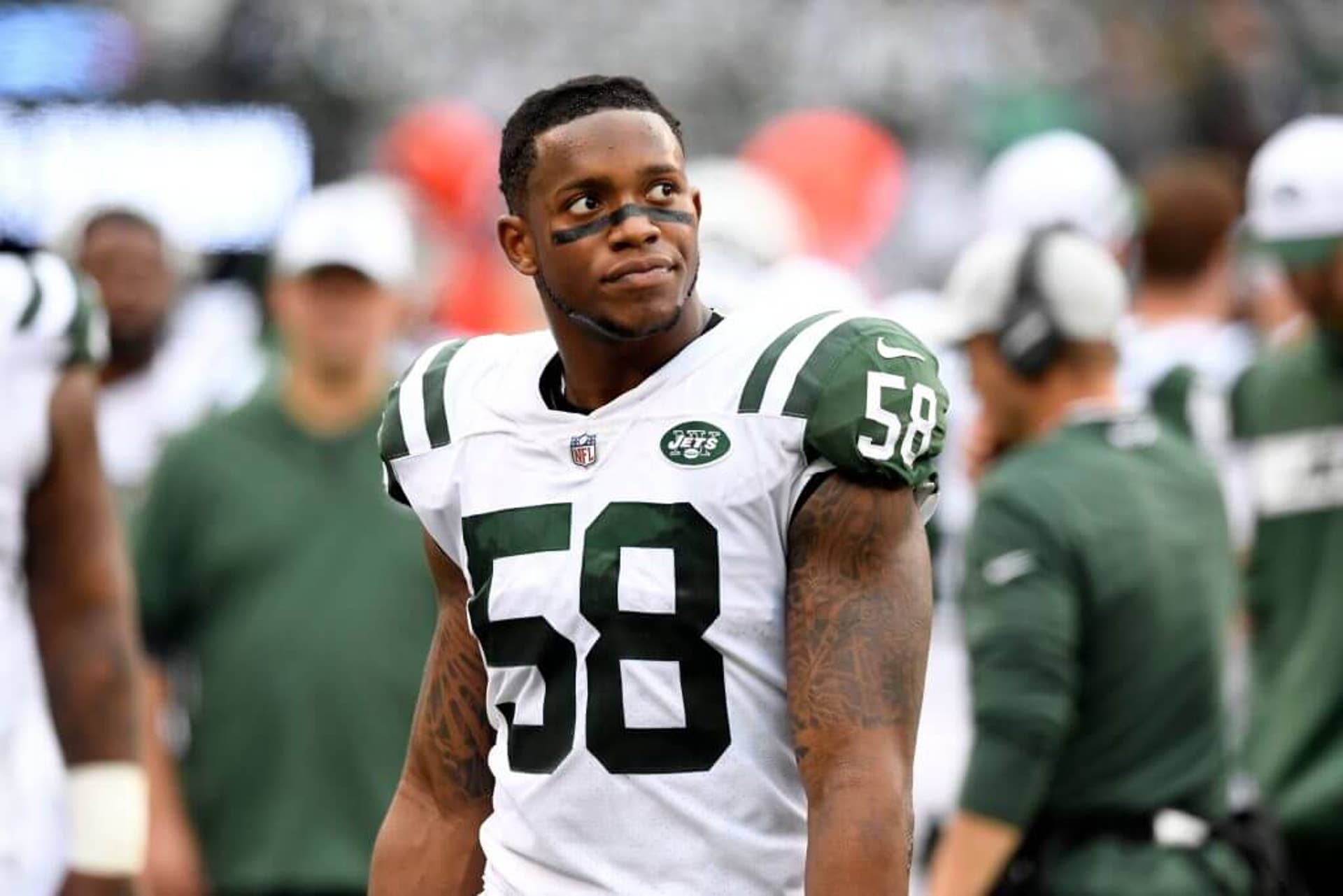 New York Jets linebacker Darron Lee looks to his left while not wearing his helmet.