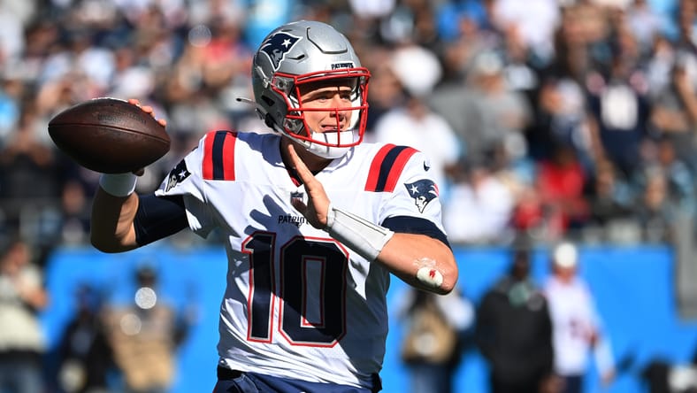 Mac Jones prepares to throw a pass during a Patriots game against the Panthers.