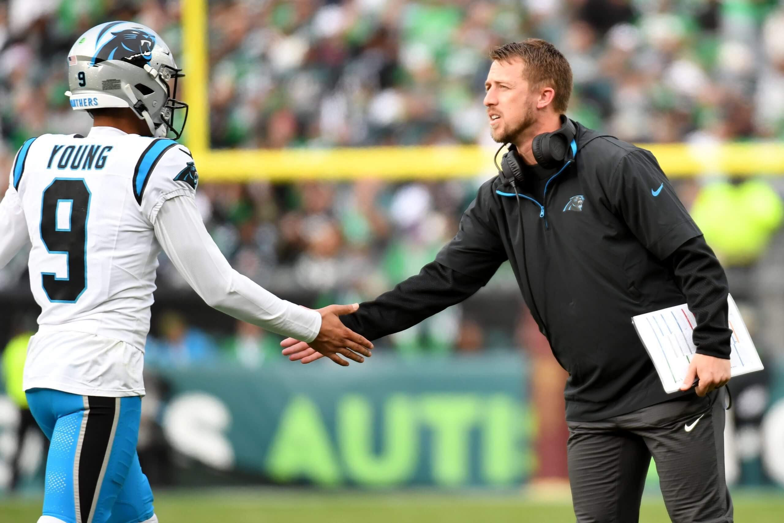 Carolina Panthers quarterback Bryce Young (9) and offensive coordinator Brad Idzik shake hands against the Philadelphia Eagles