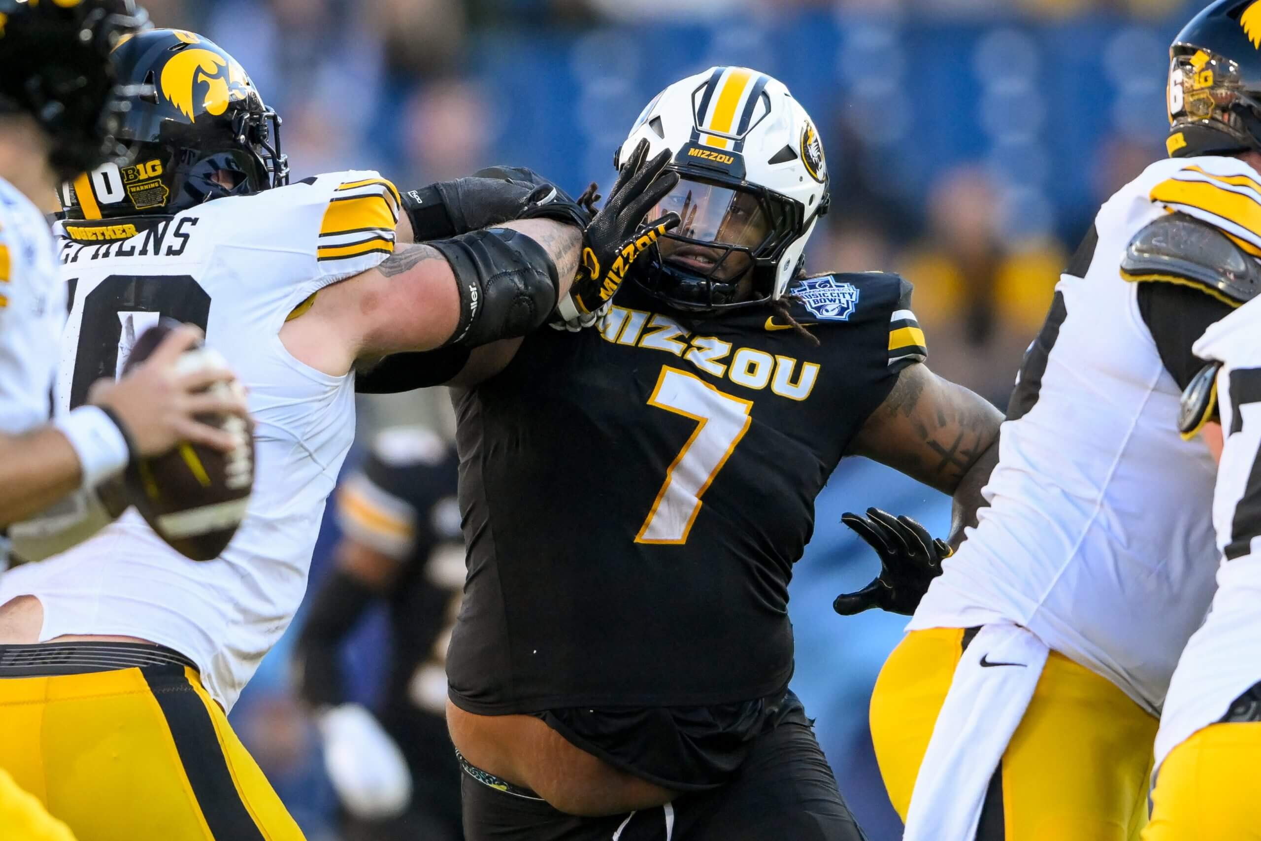 Missouri Tigers defensive tackle Chris McClellan rushes Iowa Hawkeyes quarterback Brendan Sullivan.