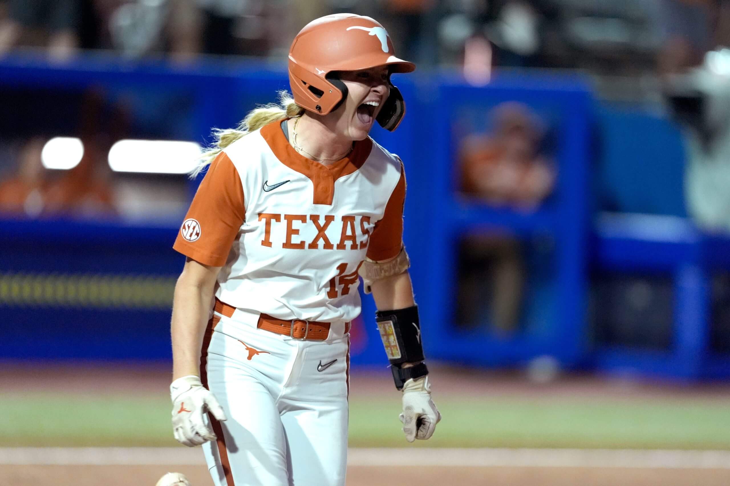 Texas' Reese Atwood yells with the bat in hand.