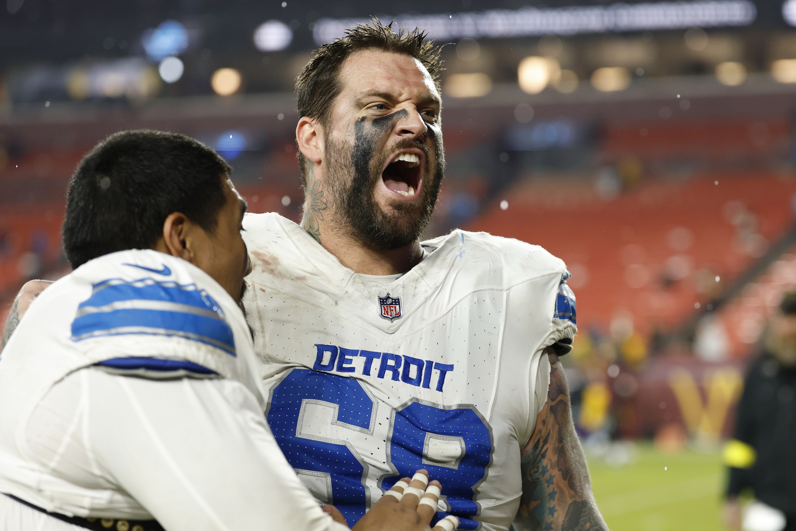 Detroit Lions offensive tackle Penei Sewell (L) celebrates with Lions offensive tackle Taylor Decker (68), who could join the Chicago Bears