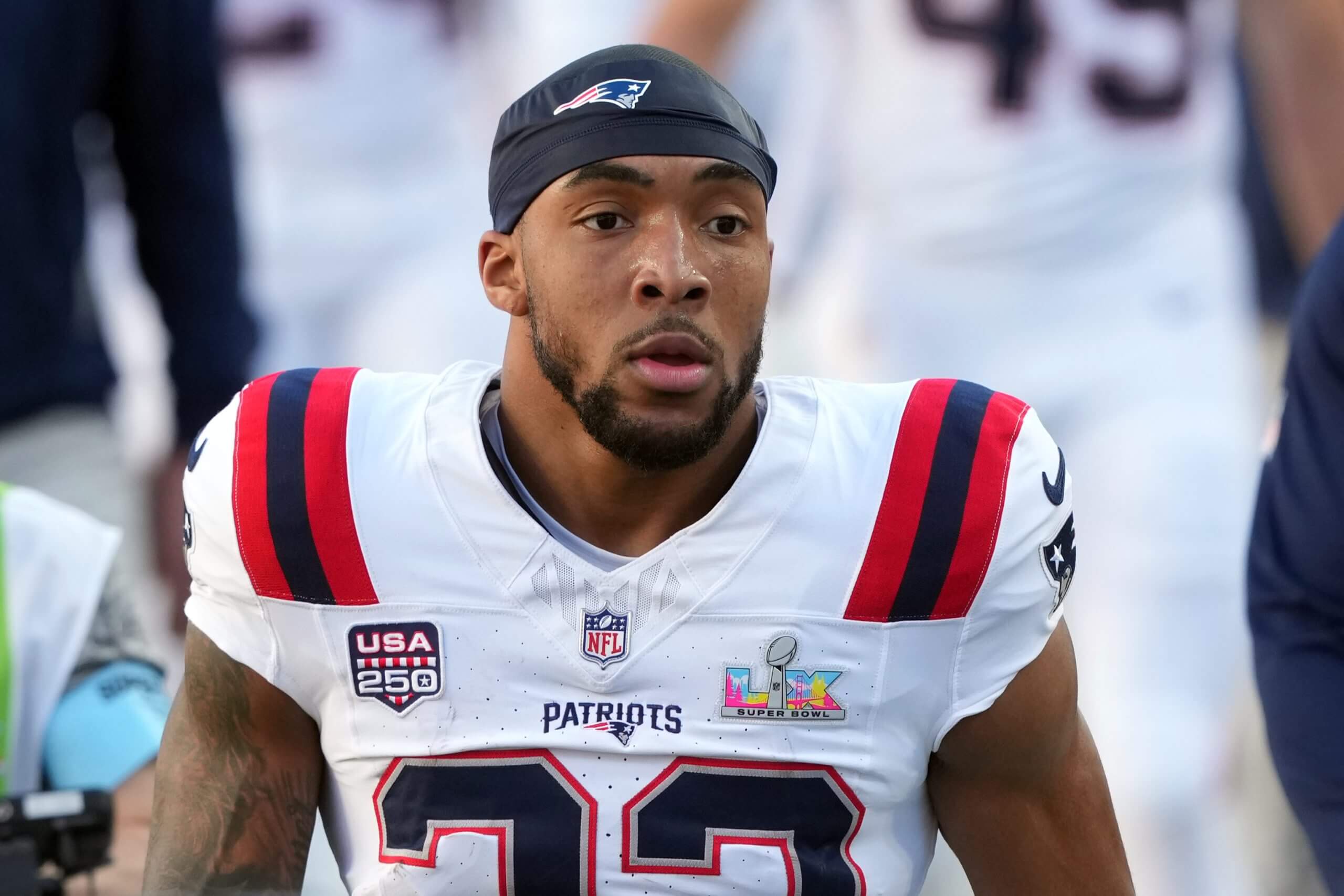 New England Patriots running back TreVeyon Henderson looks on durin gan NFL game.