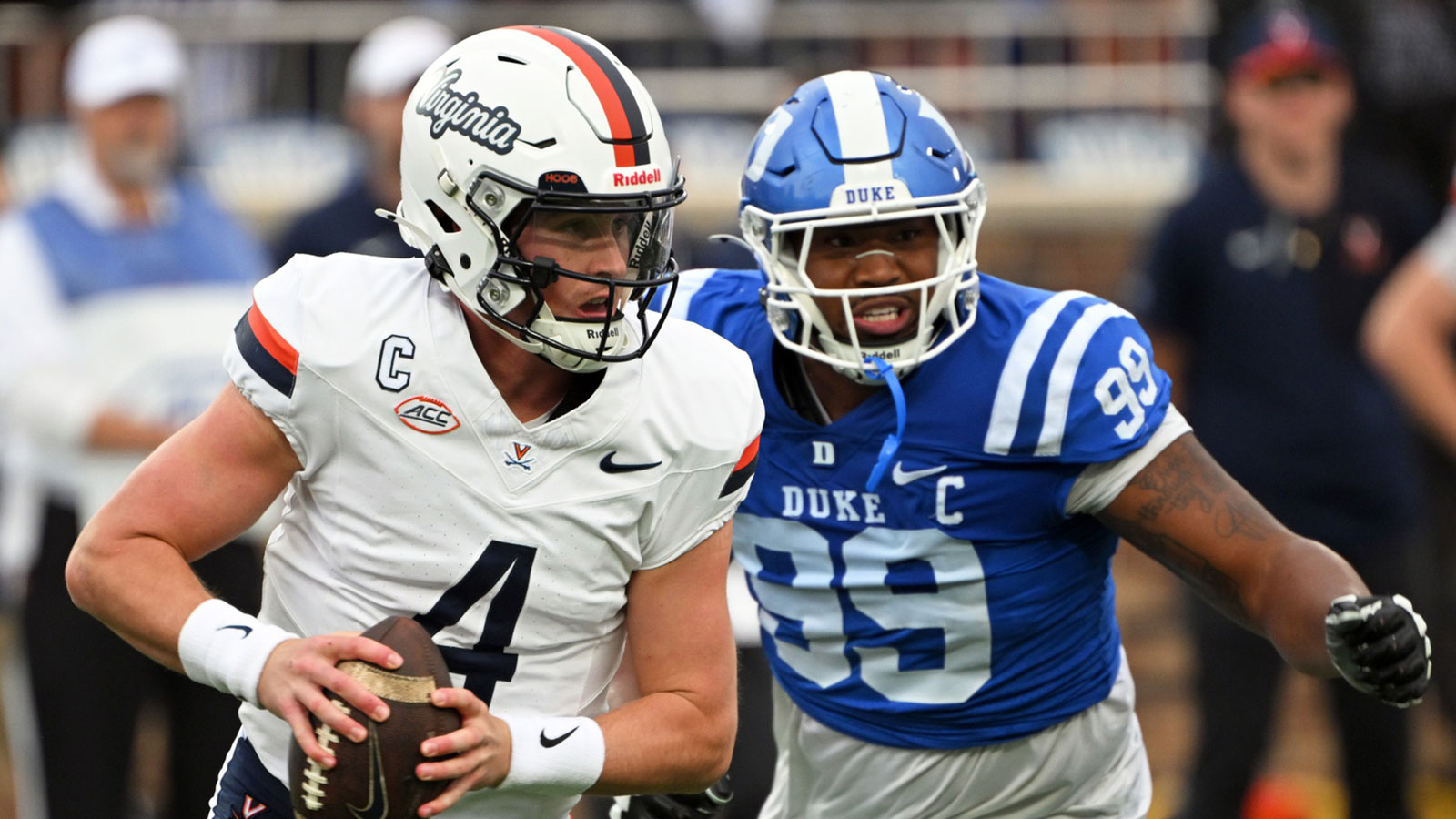 Virginia Cavaliers quarterback Chandler Morris (4) looks for an opening against Duke Blue Devils defensive tackle Aaron Hall (99) during the first quarter at Wallace Wade Stadium.