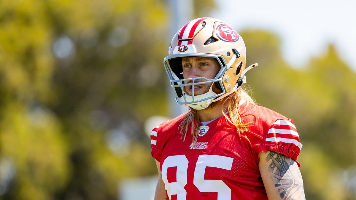 George Kittle walks on practice field