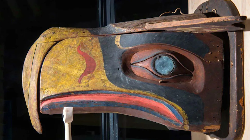 The original mask of a bird, with a yellow beak and red and blue colouring