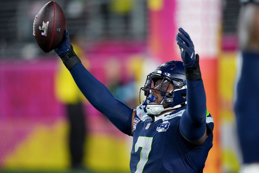 Seattle Seahawks linebacker Uchenna Nwosu celebrates after recovering a fumble and returning it for a touchdown.