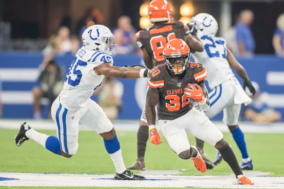 Cleveland Browns running back D'Ernest Johnson (30) of Immokalee runs the ball while Indianapolis Colts cornerback Pierre Desir (35) defends in the second quarter of the game at Lucas Oil Stadium.