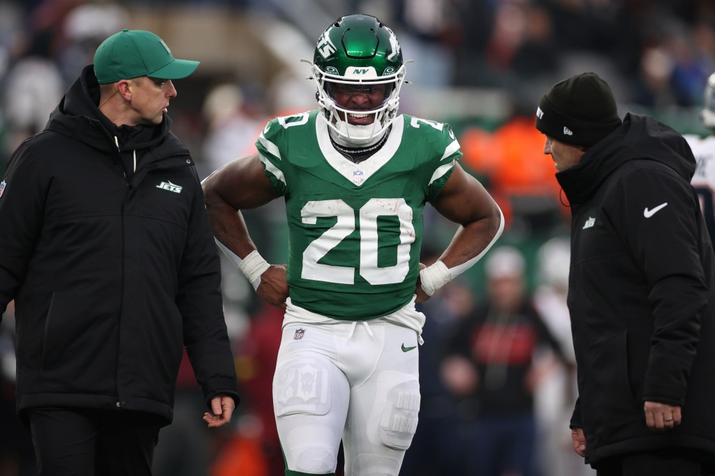 Breece Hall of the New York Jets in his uniform, reacting after an injury.