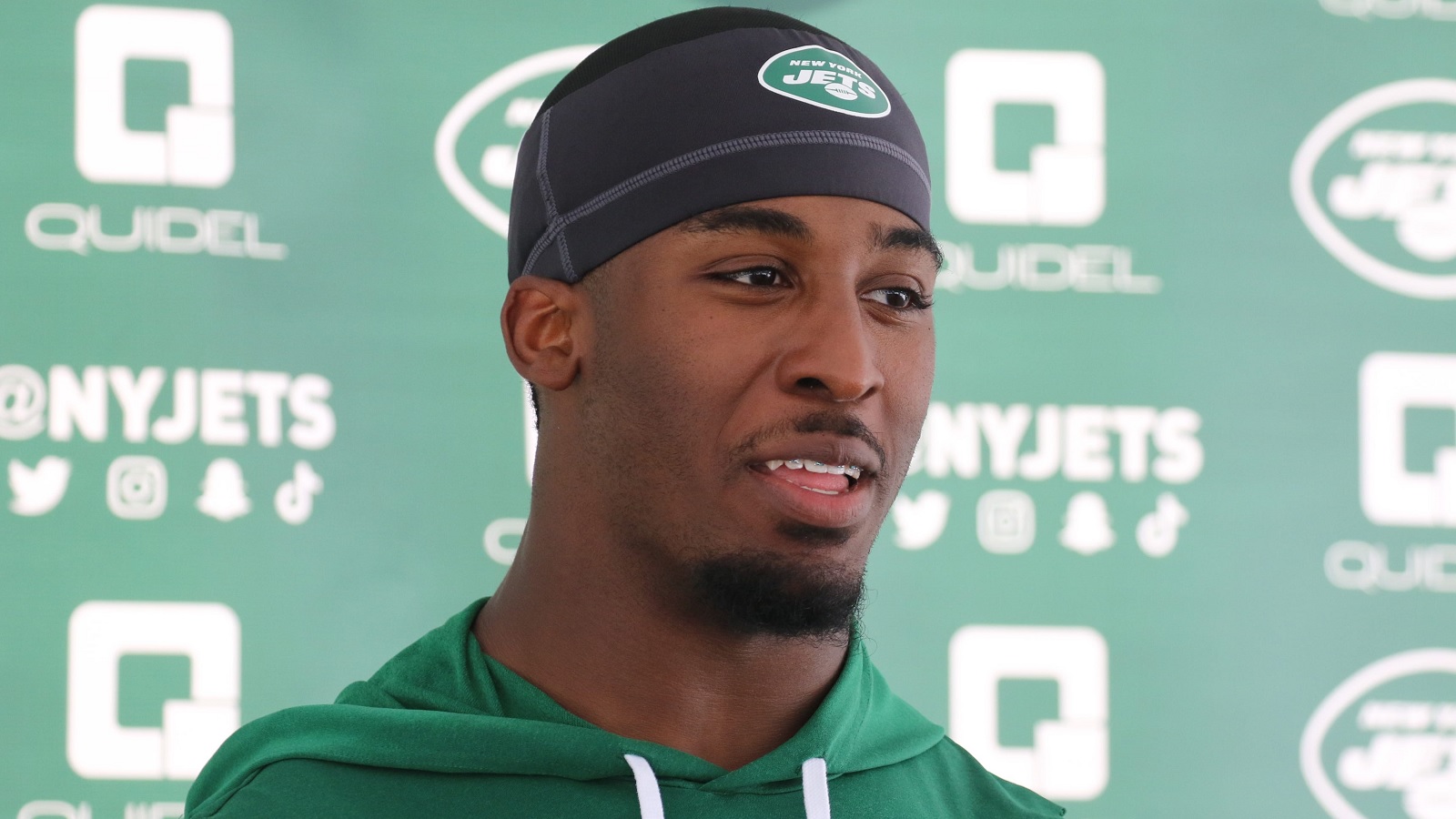 Breece Hall talks with the media