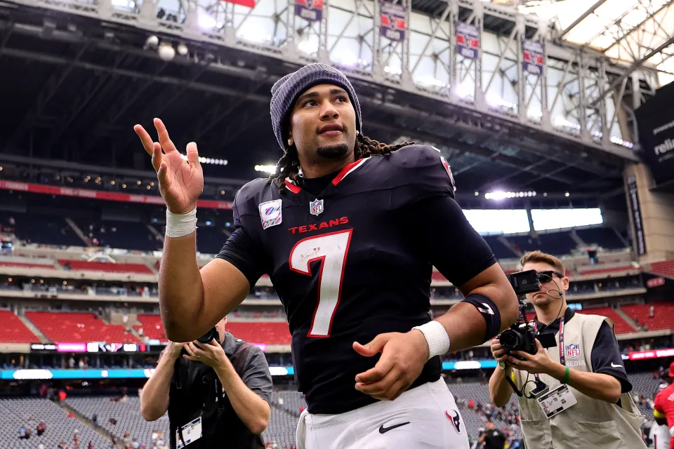C.J. Stroud of the Houston Texans celebrates a win against the Tennessee Titans as he runs off the field after the game at NRG Stadium on September 28, 2025