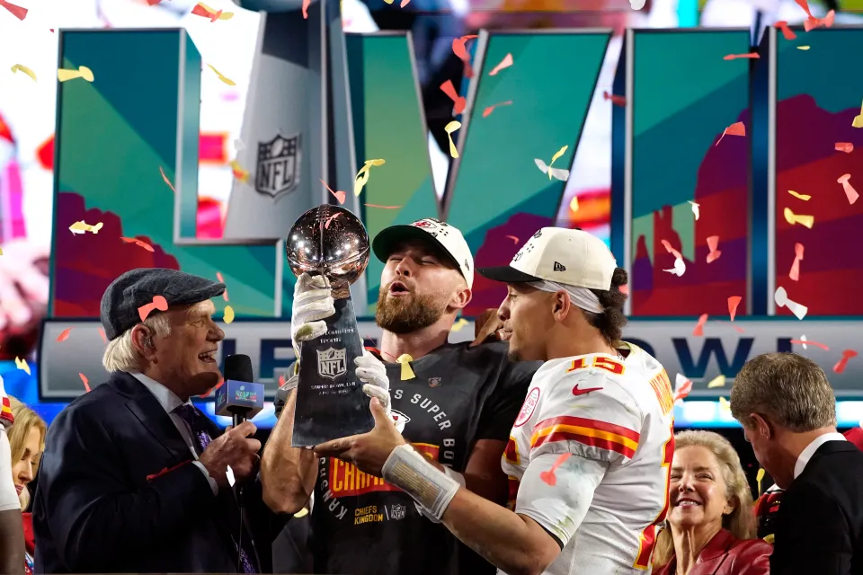Travis Kelce lifts the Super Bowl trophy