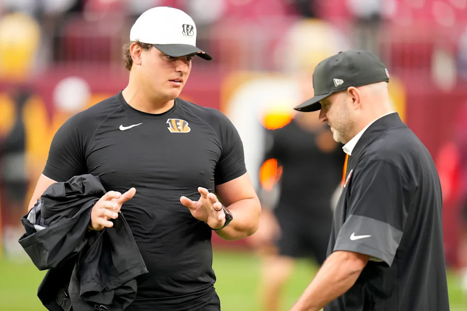 Cincinnati Bengals defensive end Trey Hendrickson talks with director of player personnel Duke Tobin