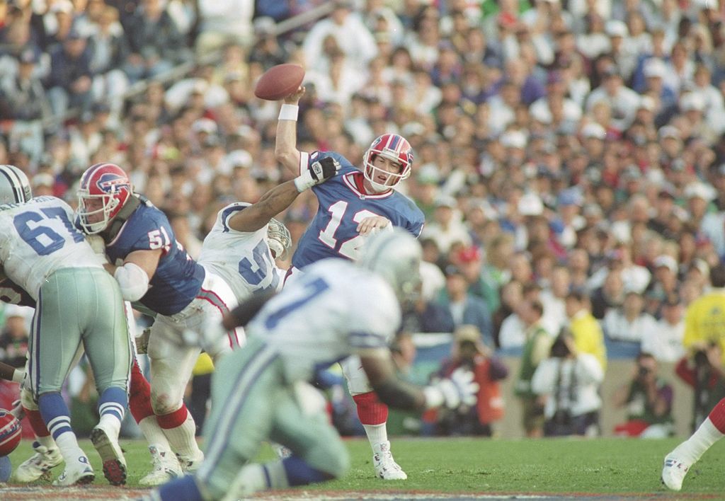 31 Jan 1993: Quarterback Jim Kelly # 12 of the Buffalo Bills is hit by linebacker Ken Norton Jr. #51 of the Dallas Cowboys at Super Bowl XXVII at the Rose Bowl in Pasadena, California. The Cowboys defeated the Bills 52-17. Mandatory Cre