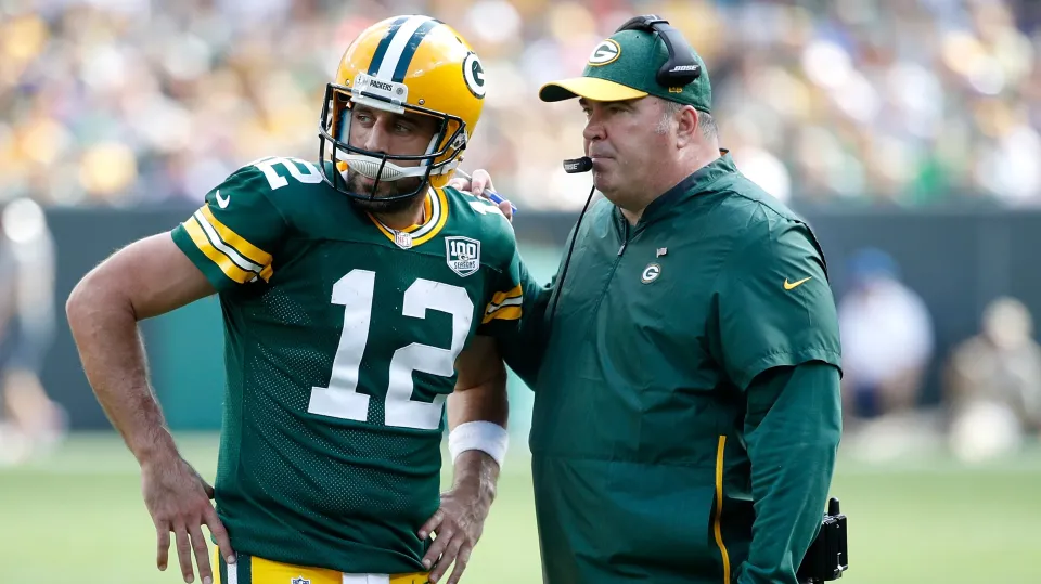 Aaron Rodgers #12 of the Green Bay Packers talks with head coach Mike McCarthy during the fourth quarter of a game against the Minnesota Vikings at Lambeau Field on September 16, 2018