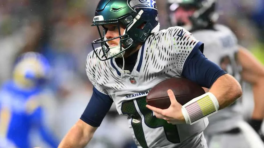 Seahawks' Sam Darnold running with the ball in the Week 16 game versus the Rams.