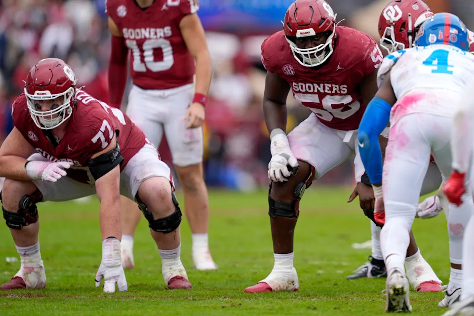 Oklahoma Sooners offensive lineman Heath Ozaeta (77) and offensive lineman Michael Fasusi (56) line up during a college football game between the University of Oklahoma Sooners (OU) and the Ole Miss Rebels at Gaylord Family Ð Oklahoma Memorial Stadium in Norman, Okla., Saturday, Oct. 25, 2025. Ole Miss won 34-26.