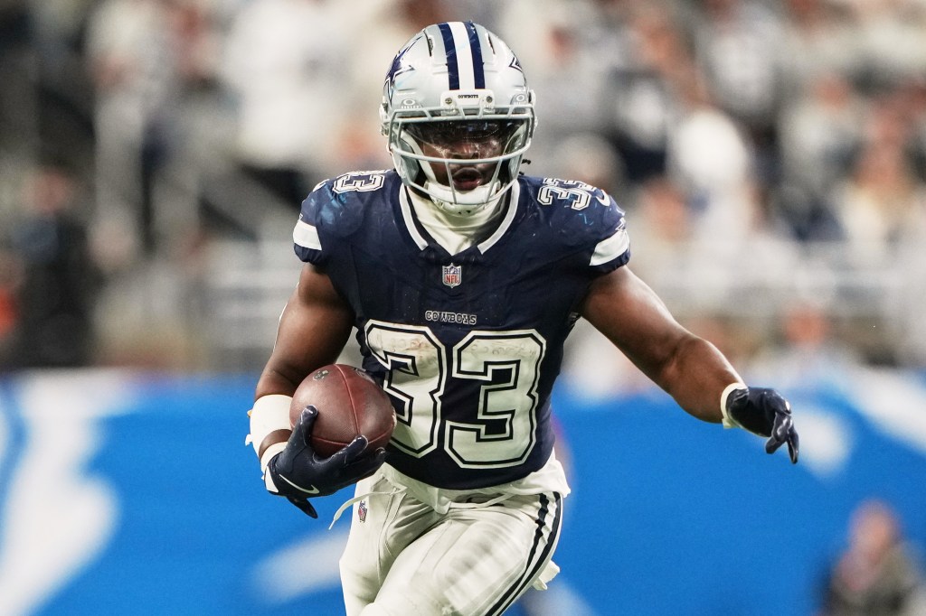 Dallas Cowboys running back Javonte Williams running with the football during a game.