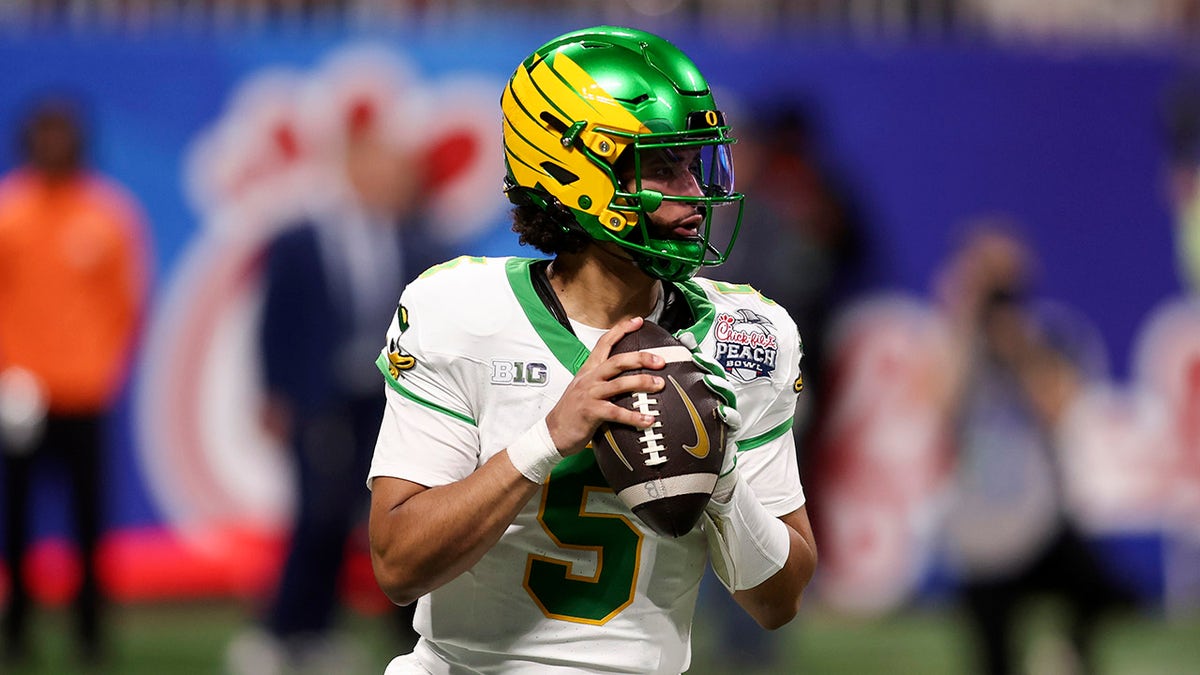 Dante Moore looks to throw