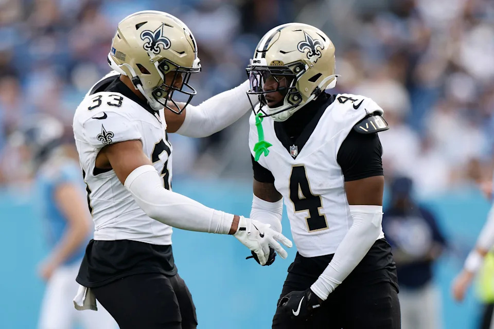 NASHVILLE, TENNESSEE - DECEMBER 28: Jonas Sanker #33 and Kool-Aid McKinstry #4 of the New Orleans Saints react after a defensive stop during the fourth quarter of the game against the Tennessee Titans at Nissan Stadium on December 28, 2025 in Nashville, Tennessee. (Photo by Johnnie Izquierdo/Getty Images)