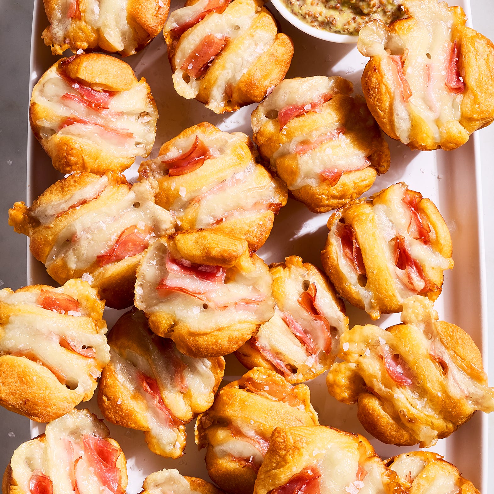 ham and swiss hasselback biscuit bites on a tray