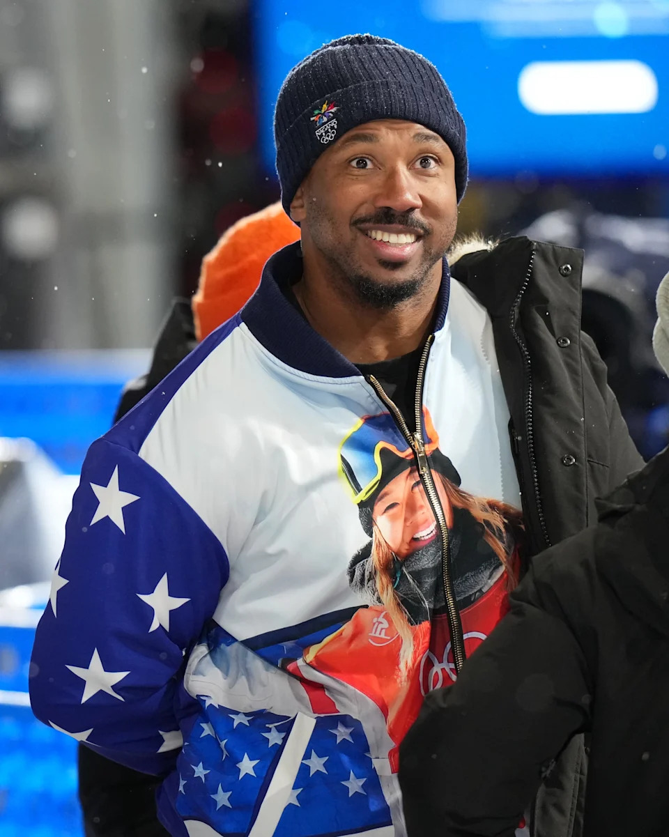Cleveland Browns player Myles Garrett wears a jacket with a photo of Chloe Kim of the United States.